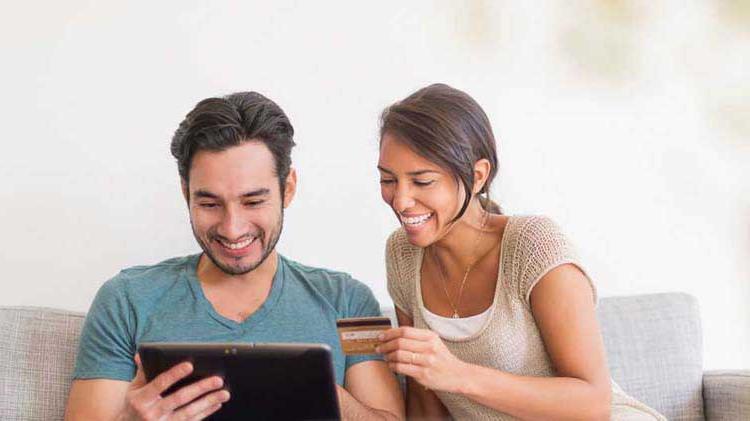 Couple shopping online with a credit card.